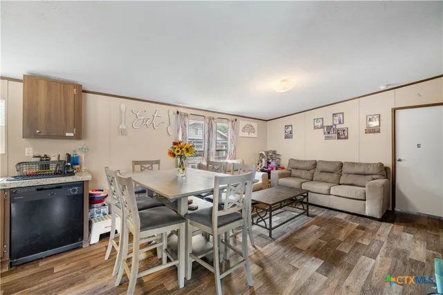 a living room with furniture and kitchen view