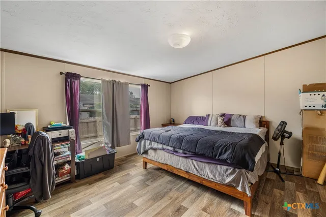 a bed room with a bed and a television