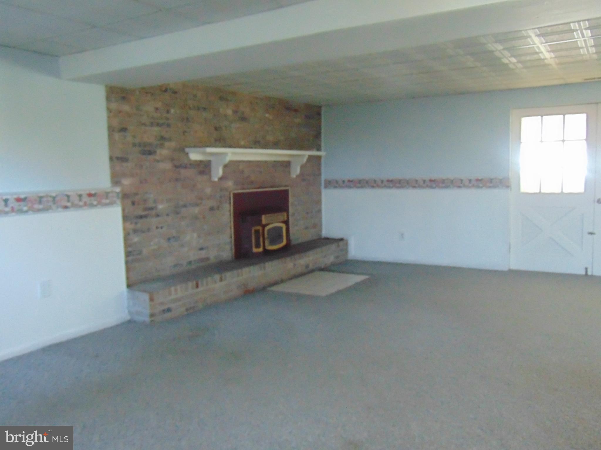 11904 Caspian Road Kingsville, MD 21087 - Photo 11 of 15 L-Shape Family Room Woodburning Brick Heath FP
