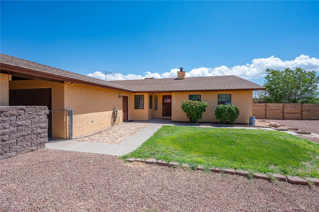 4100 North Skylark Road Kingman, AZ 86409 - Photo 1 of 60 View of front of property featuring stucco siding, a chimney, an attached garage, and roof with shingles