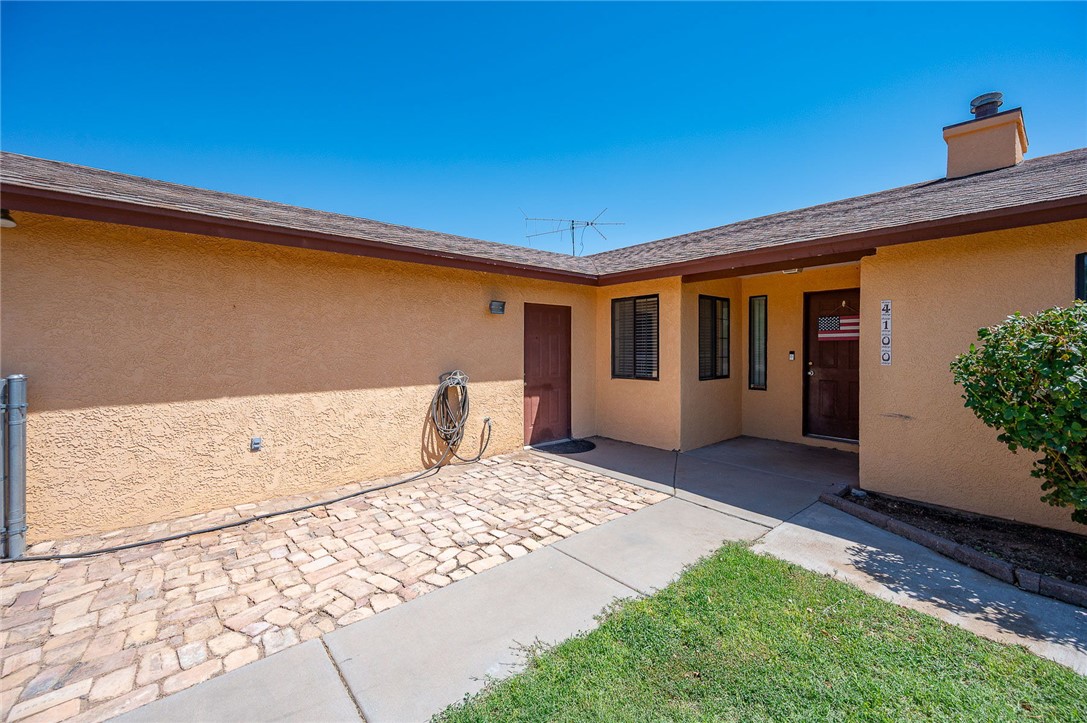 4100 North Skylark Road Kingman, AZ 86409 - Photo 2 of 60 Property entrance featuring stucco siding and a chimney
