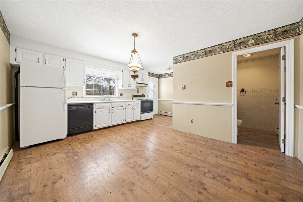 4 Shawsheen Road, Unit 2 Lawrence, MA 01843 - Photo 21 of 35 a kitchen with stainless steel appliances a refrigerator and a stove top oven