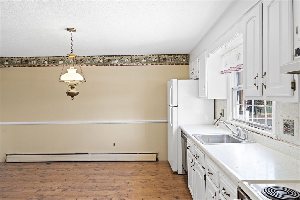 4 Shawsheen Road, Unit 2 Lawrence, MA 01843 - Photo 3 of 35 a kitchen with a sink a stove and a refrigerator