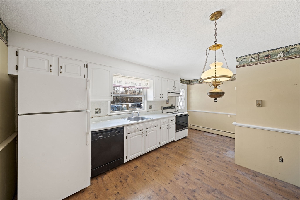 4 Shawsheen Road, Unit 2 Lawrence, MA 01843 - Photo 5 of 35 a kitchen with sink cabinets and white appliances