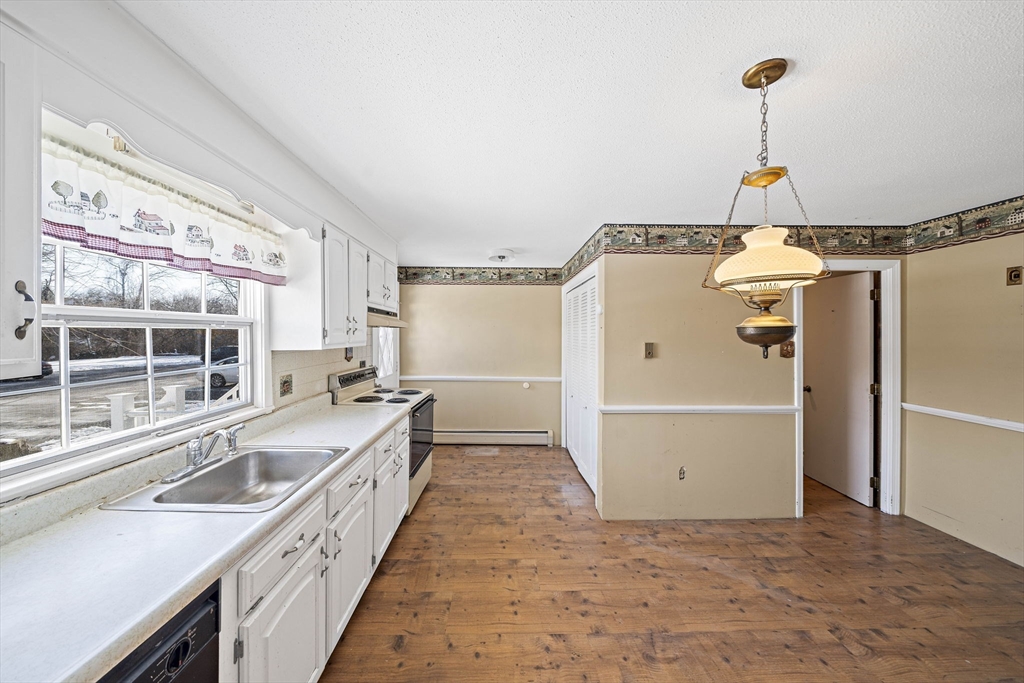 4 Shawsheen Road, Unit 2 Lawrence, MA 01843 - Photo 6 of 35 a view of a kitchen with a sink and wooden floor