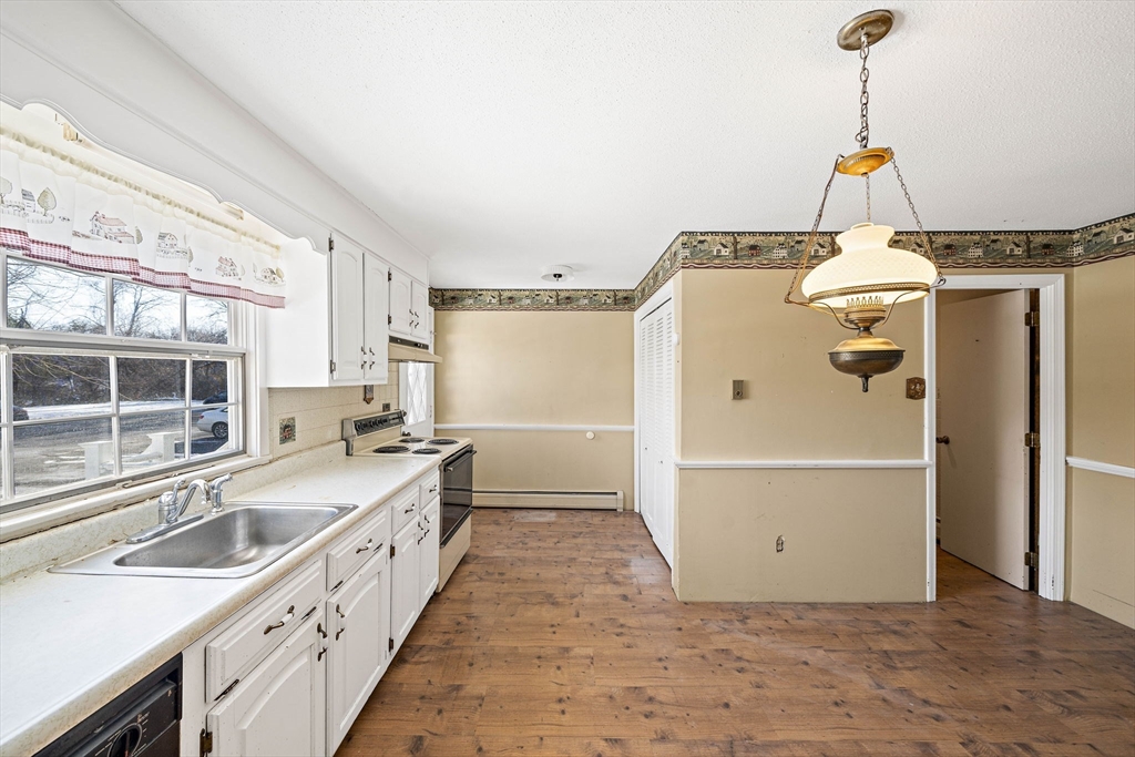4 Shawsheen Road, Unit 2 Lawrence, MA 01843 - Photo 8 of 35 a kitchen with granite countertop a sink stainless steel appliances and cabinets