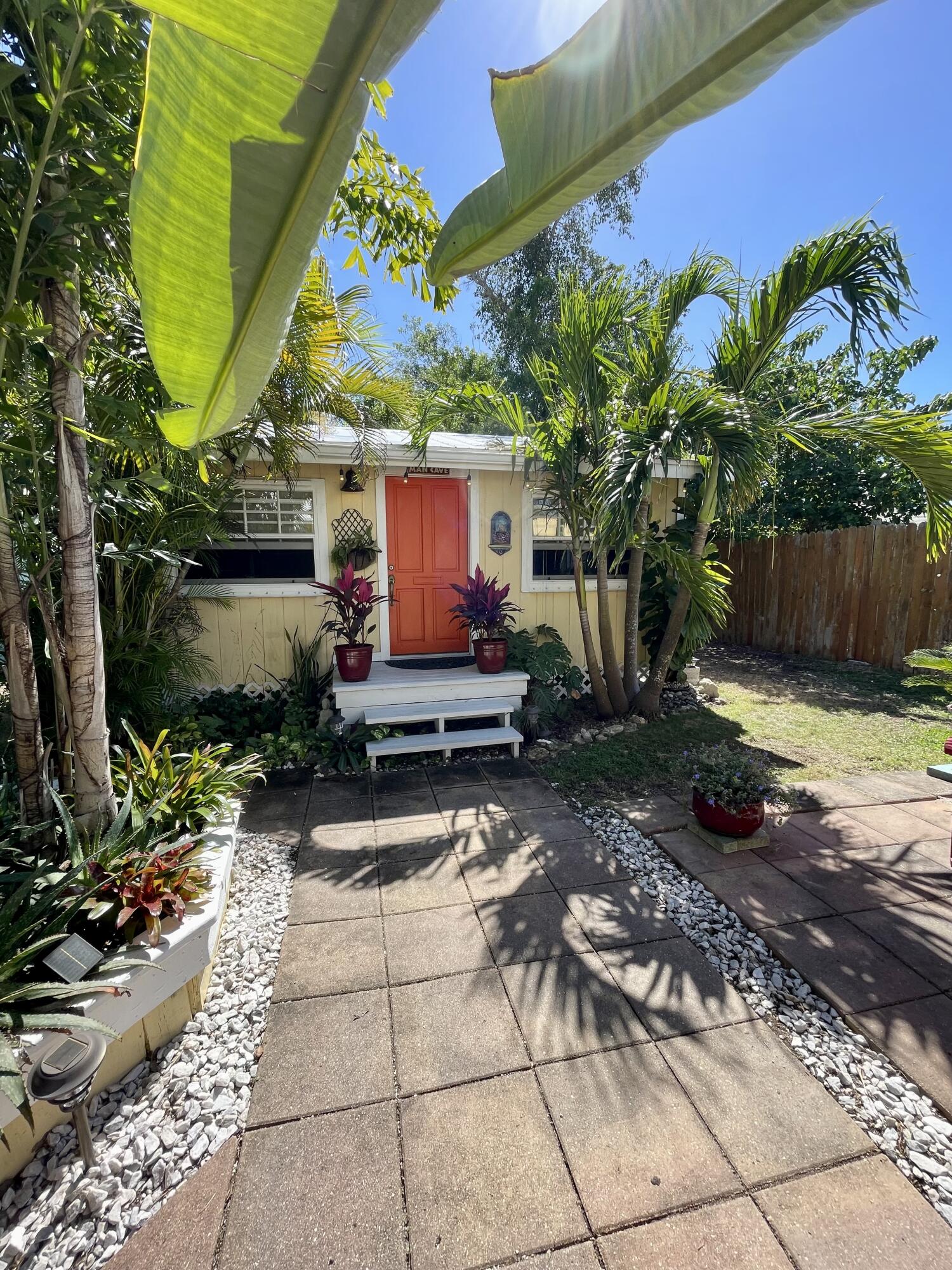 31240 Ave D Big Pine Key, FL 33043 - Photo 14 of 42 a view of a back yard of the house and a chair