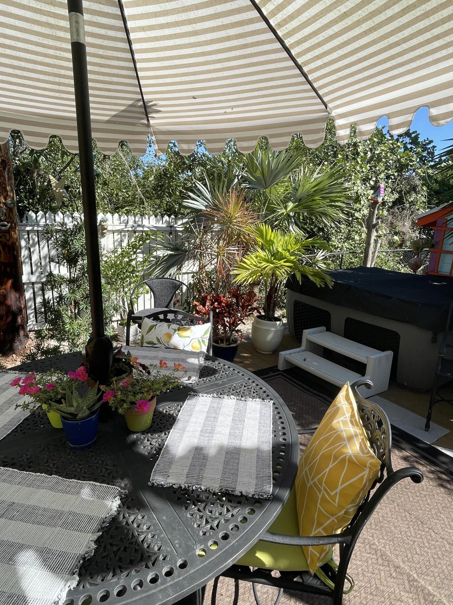 31240 Ave D Big Pine Key, FL 33043 - Photo 24 of 42 a view of a porch with furniture and a potted plant