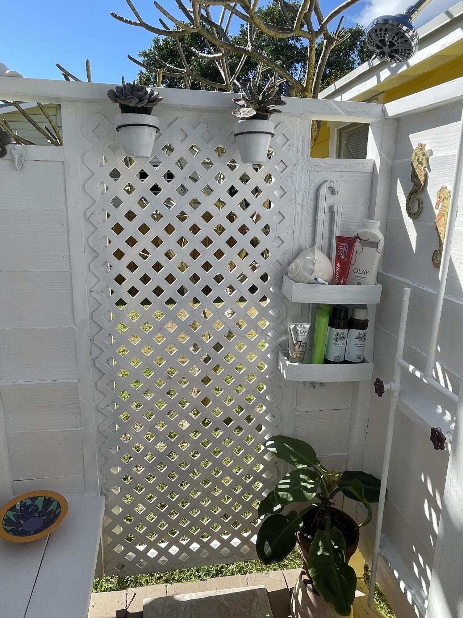 31240 Ave D Big Pine Key, FL 33043 - Photo 26 of 42 a bathroom with a toilet and a shower curtain