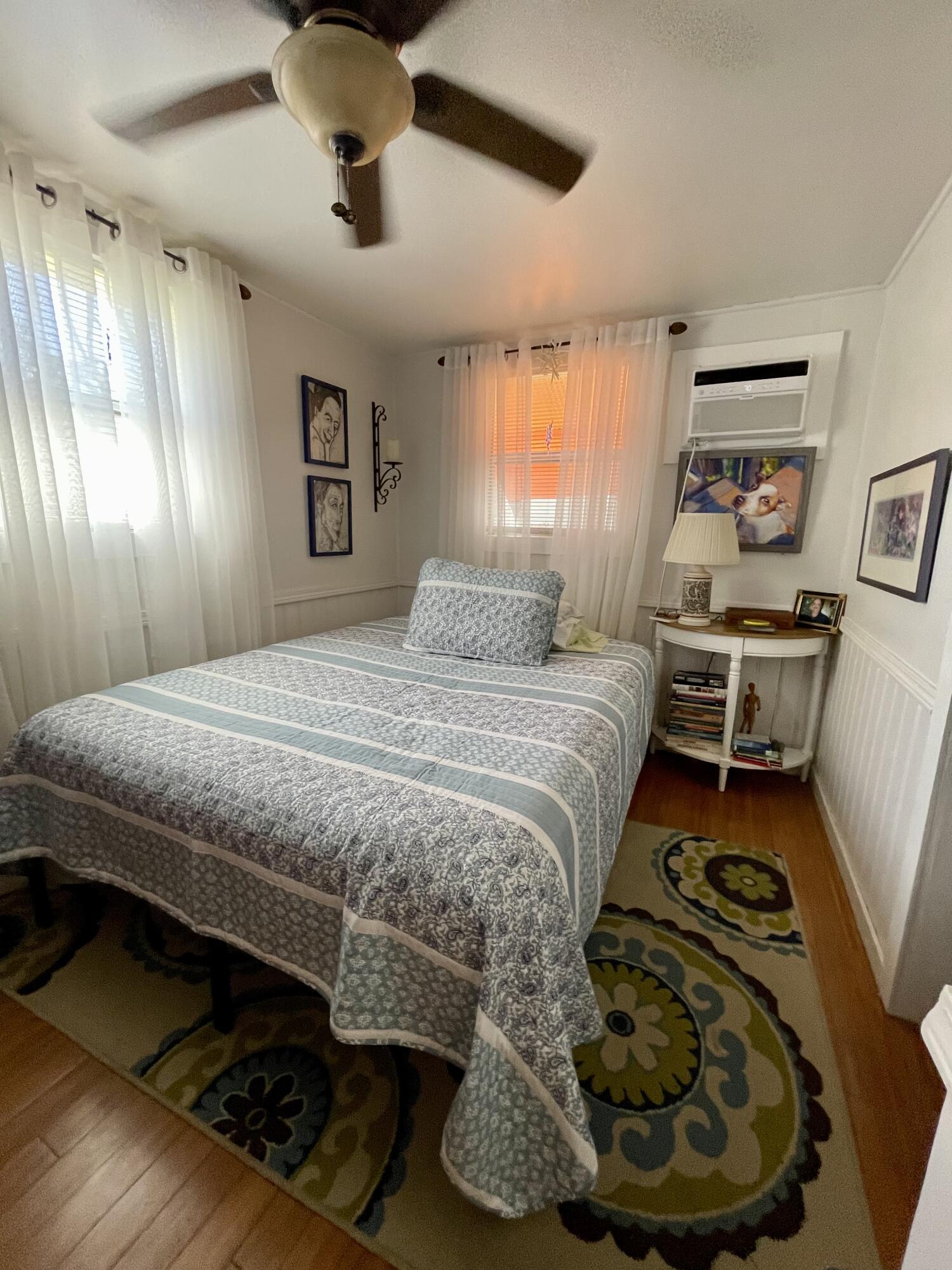 31240 Ave D Big Pine Key, FL 33043 - Photo 29 of 42 a bedroom with a bed and wooden floor