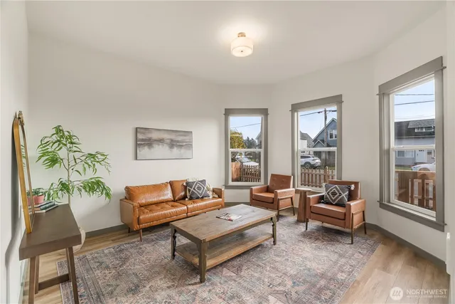 a living room with furniture and a potted plant