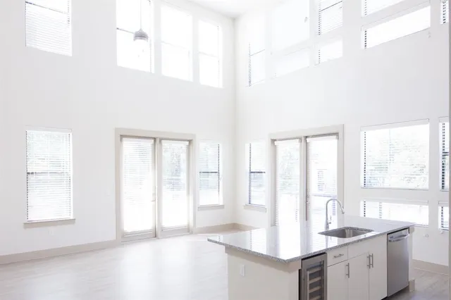 a kitchen with stainless steel appliances granite countertop a sink and a white cabinets