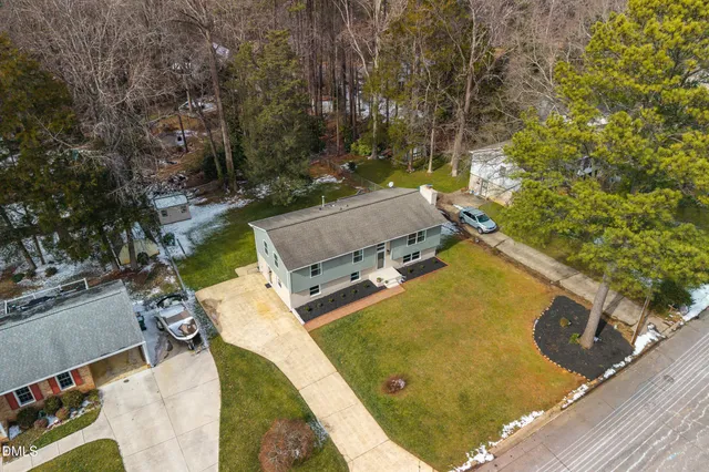 a roof deck with table and chairs with wooden floor