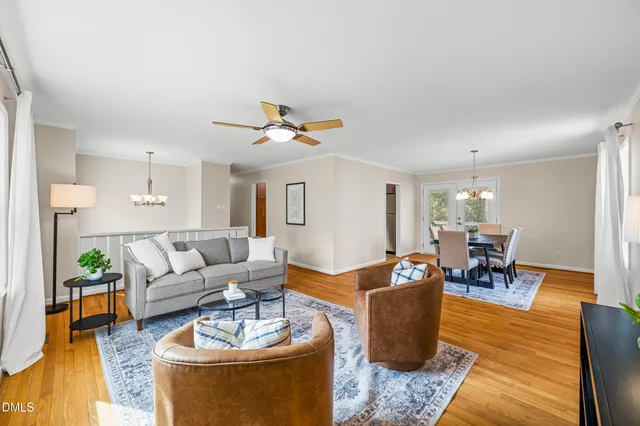 a living room with furniture a rug and a window