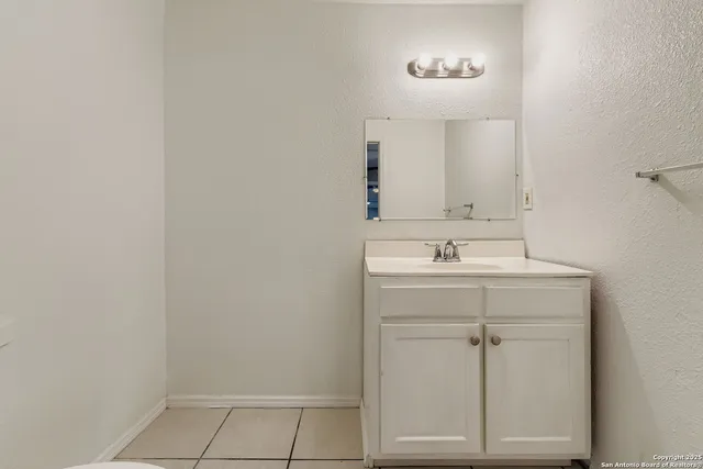 a bathroom with a sink vanity and a mirror