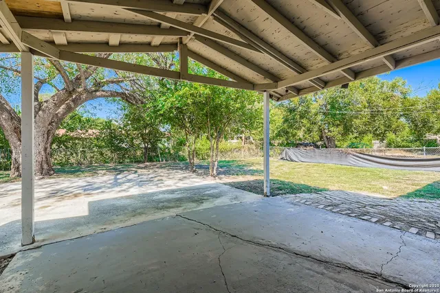 a view of a swimming pool with a yard