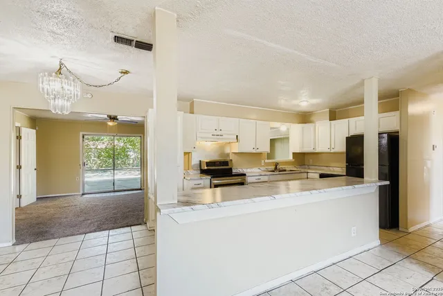 a kitchen with stainless steel appliances a stove refrigerator sink and cabinets