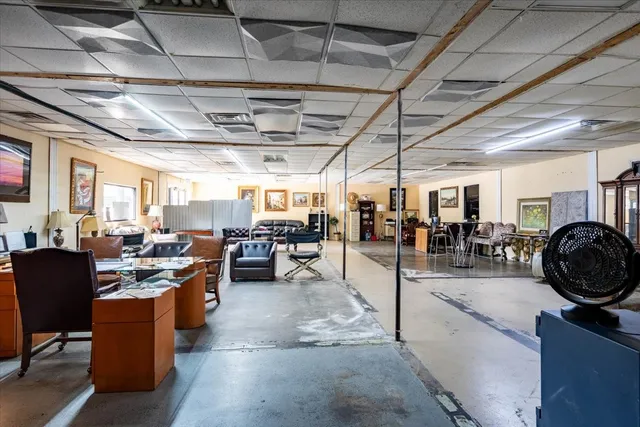 a living room with lots of furniture and kitchen