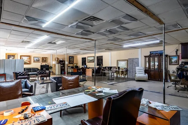 a living room with lots of furniture a desk and chair