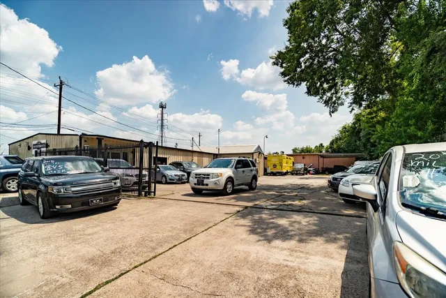 a view of a cars park in front of a house