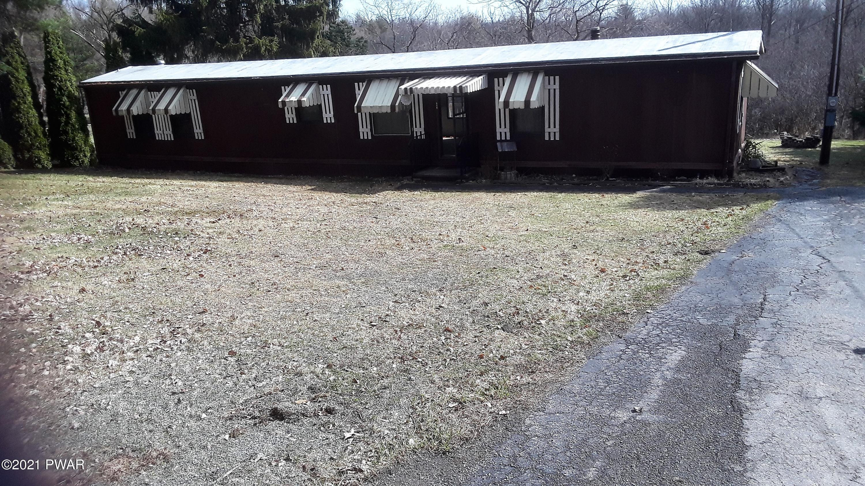 526 Cortez Road Lake Ariel, PA 18436 - Photo 2 of 21 a view of wooden house with a yard