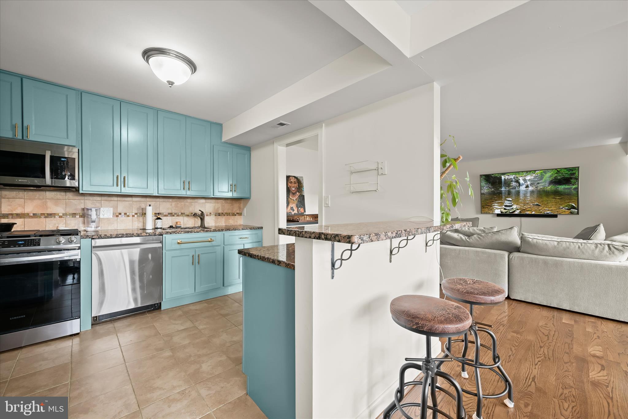 a kitchen with cabinets and chairs