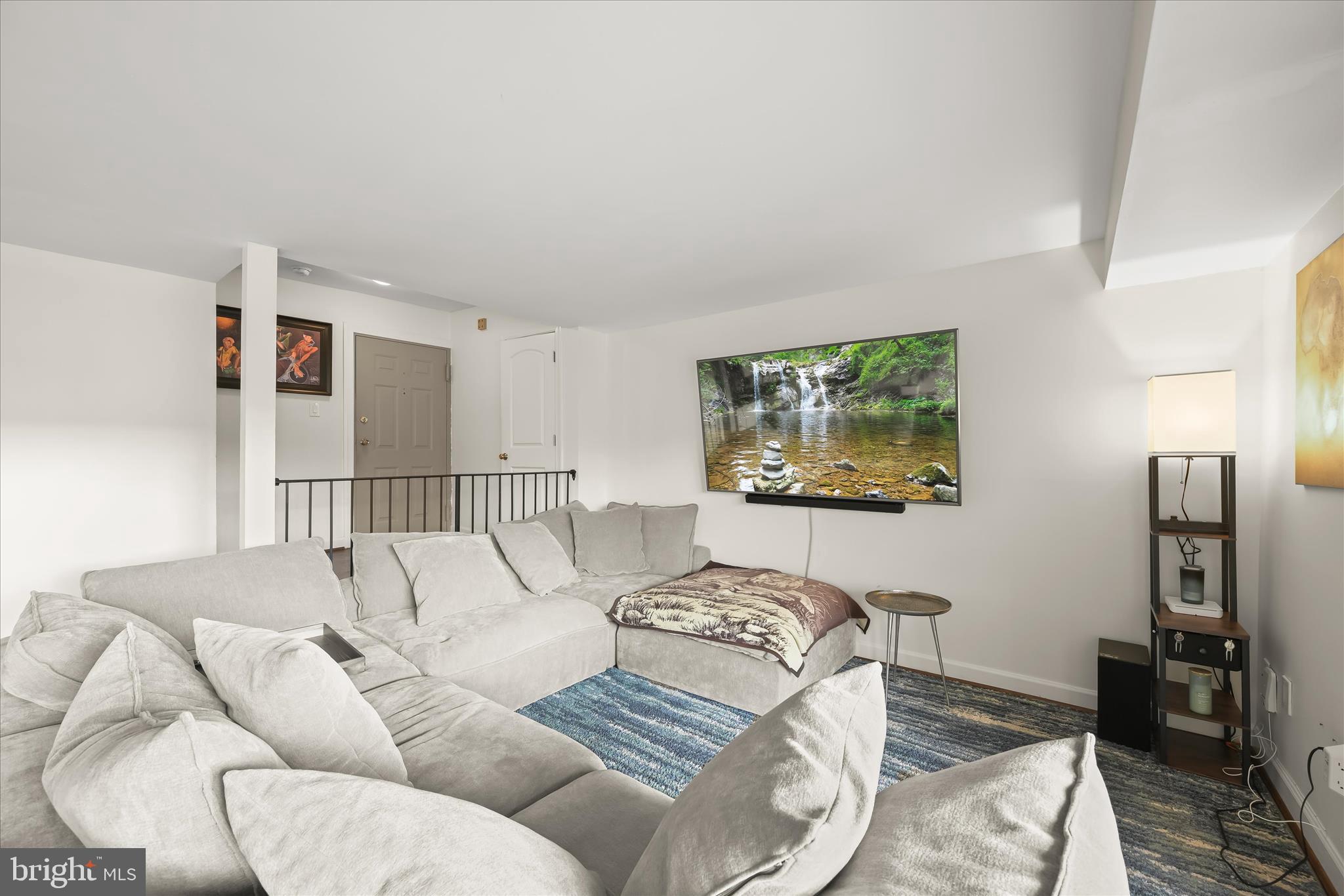 10851-10859 Amherst Avenue, Unit 202 Silver Spring, MD 20902 - Photo 9 of 32 a living room with furniture and a flat screen tv