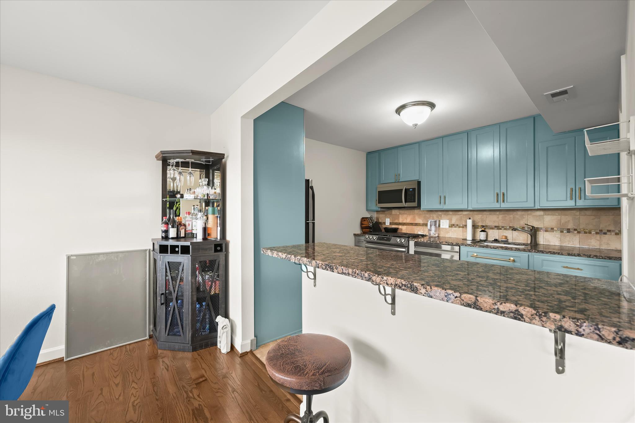 10851-10859 Amherst Avenue, Unit 202 Silver Spring, MD 20902 - Photo 9 of 32 a kitchen with stainless steel appliances granite countertop a refrigerator a stove and a sink with granite countertops