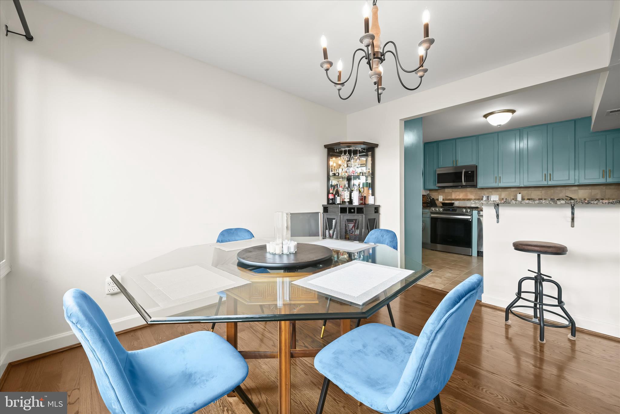 10851-10859 Amherst Avenue, Unit 202 Silver Spring, MD 20902 - Photo 15 of 32 a view of a dining room with furniture and wooden floor