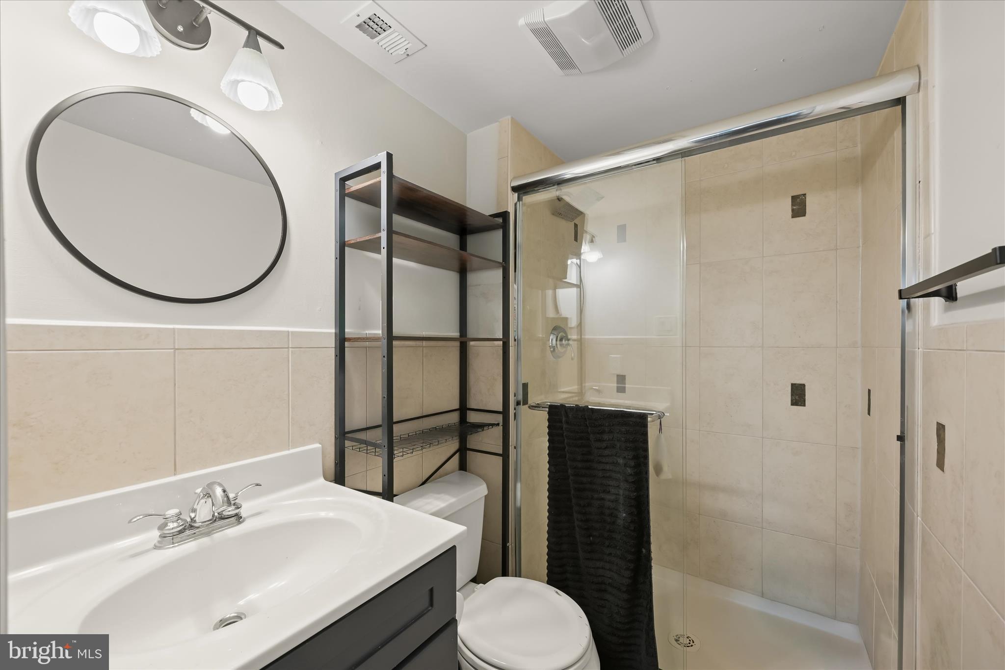 10851-10859 Amherst Avenue, Unit 202 Silver Spring, MD 20902 - Photo 18 of 32 a bathroom with a sink toilet and shower