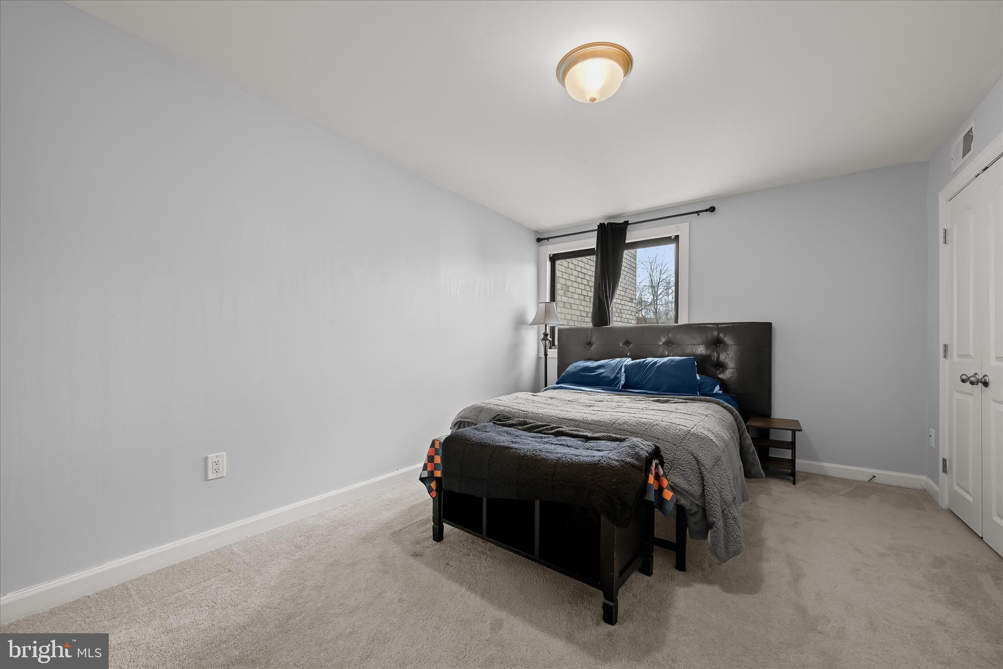 10851-10859 Amherst Avenue, Unit 202 Silver Spring, MD 20902 - Photo 19 of 32 a bedroom with a bed and window