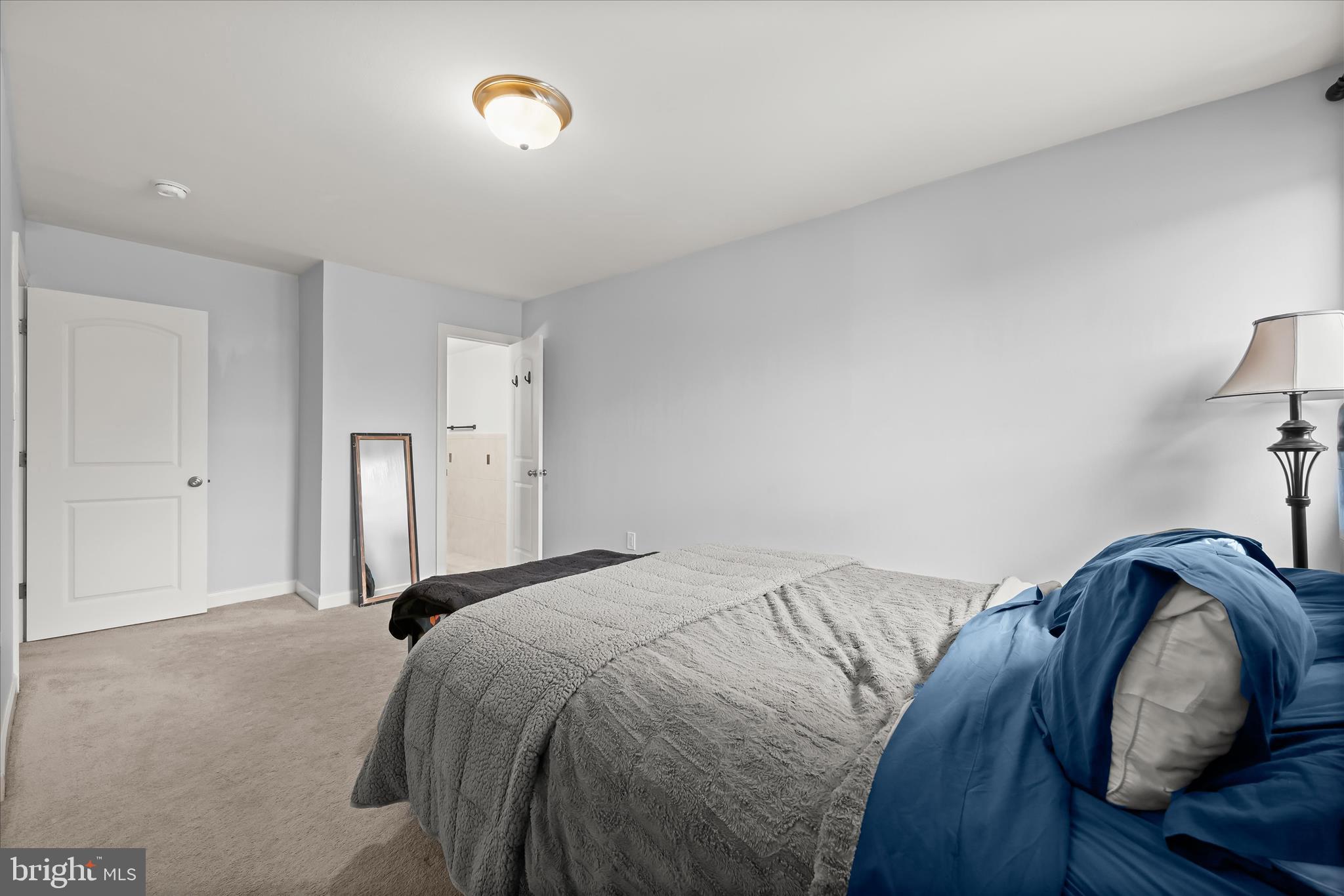 10851-10859 Amherst Avenue, Unit 202 Silver Spring, MD 20902 - Photo 20 of 32 a bed sitting in a bedroom next to a larger window