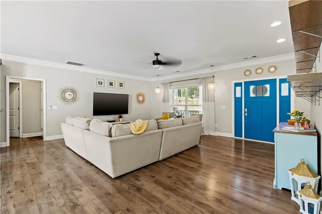 a living room with furniture and a flat screen tv