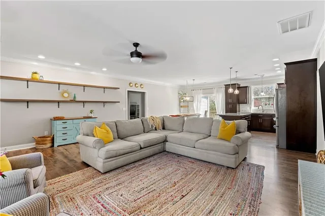a living room with furniture and kitchen view