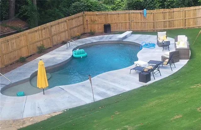 a view of a backyard with sitting area