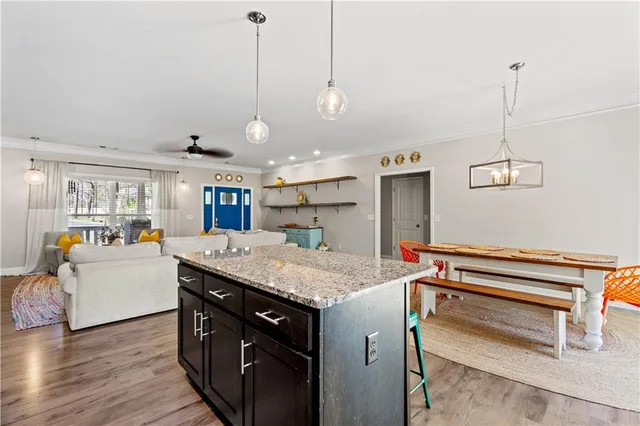 a kitchen with a stove and a wooden floor