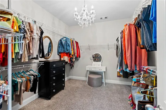 a view of walk in closet with clothes