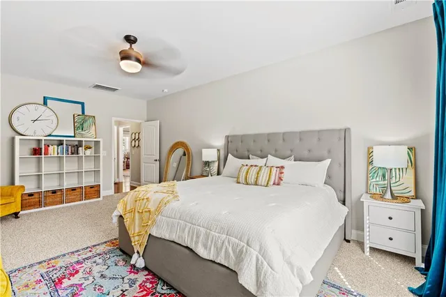 a bedroom with a bed and a book shelf