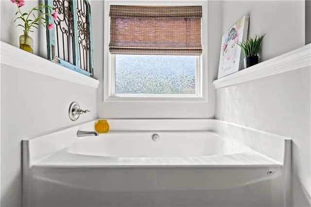 a white bath tub sitting next to a window