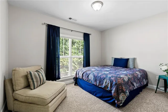 a bedroom with a bed and a couch