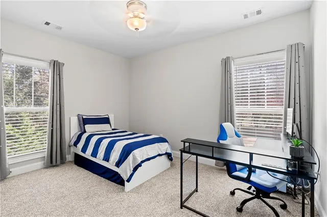 a bedroom with furniture and a window