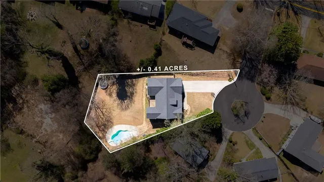 an aerial view of a house with garden space and sitting area