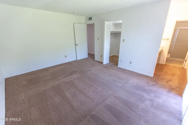 a white toilet sitting next to a shower