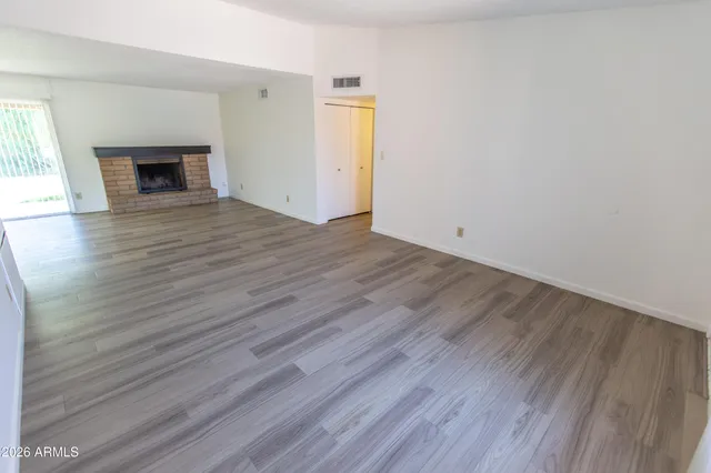 a kitchen with wooden floors and kitchen view