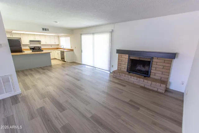 a living room with hard wood floors and a wooden floor