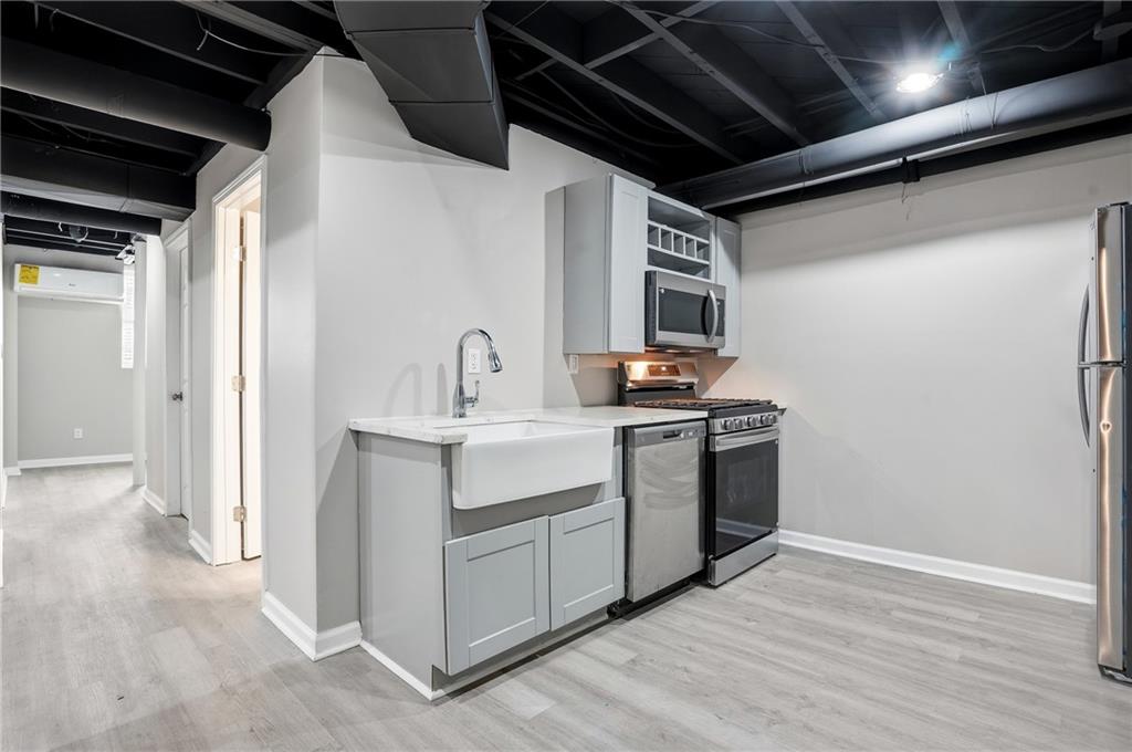 3130 Gay Drive Decatur, GA 30032 - Photo 22 of 28 a kitchen with sink a microwave and cabinets
