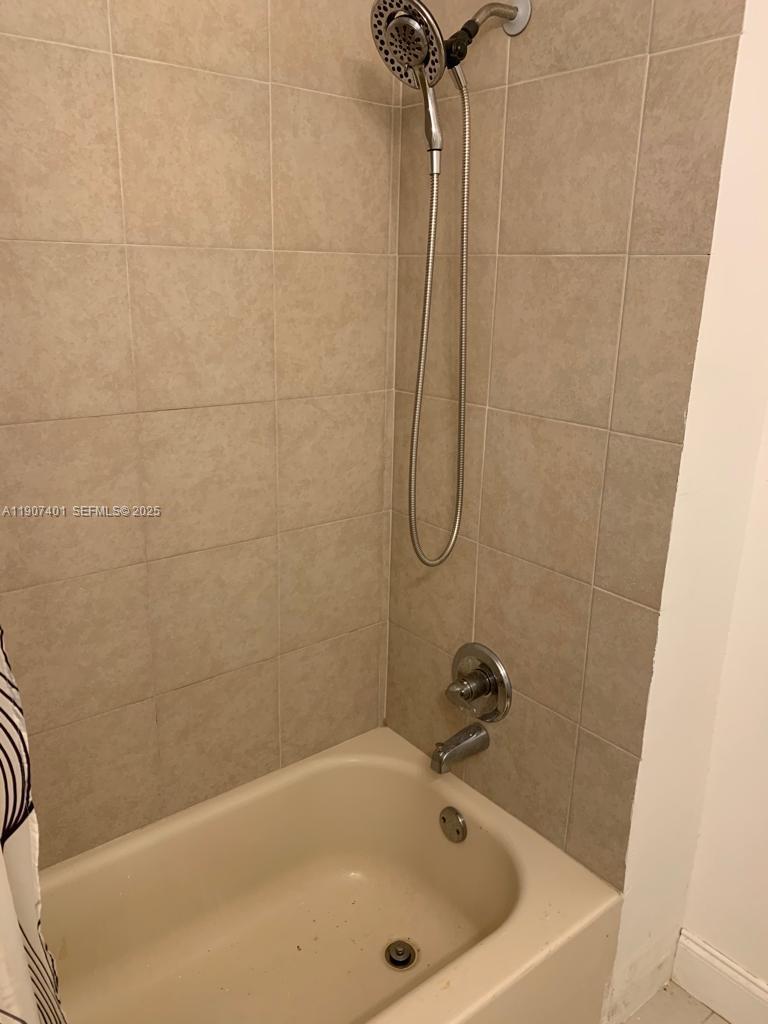 1511 Northeast 117th Street, Unit 2 Miami, FL 33161 - Photo 11 of 14 a bathroom with a bath tub and a shower