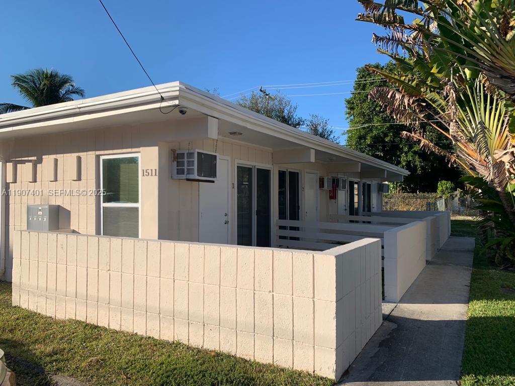 1511 Northeast 117th Street, Unit 2 Miami, FL 33161 - Photo 14 of 14 a front view of a house with a garden