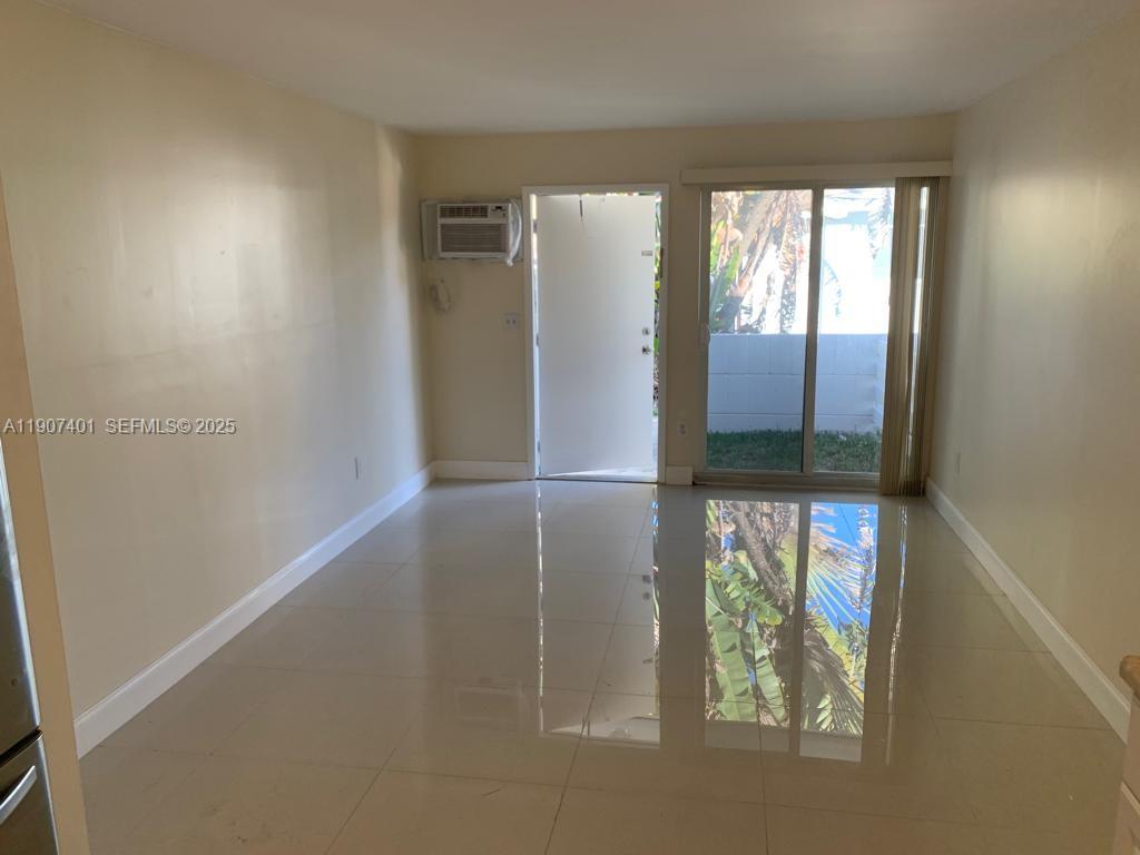 1511 Northeast 117th Street, Unit 2 Miami, FL 33161 - Photo 2 of 14 an empty room with windows and entrance