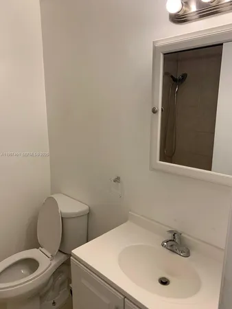 a white toilet sitting next to a bathroom sink